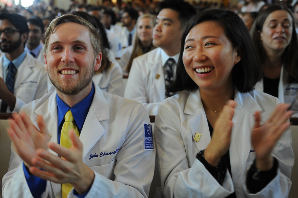 doctors in white coats celebrating